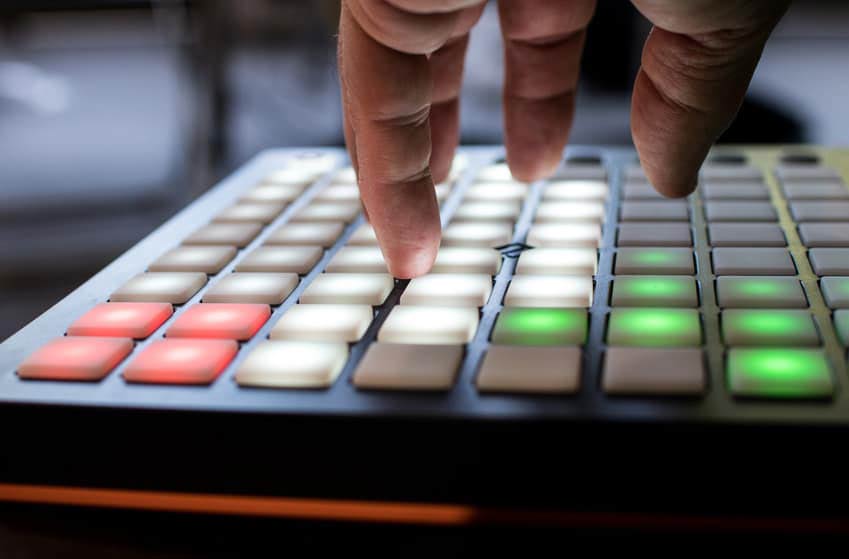Hand pressing buttons on one of the year's best cheap synthesizers
