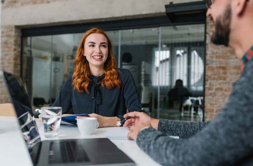 Female music intern talking to potential employer at job interview