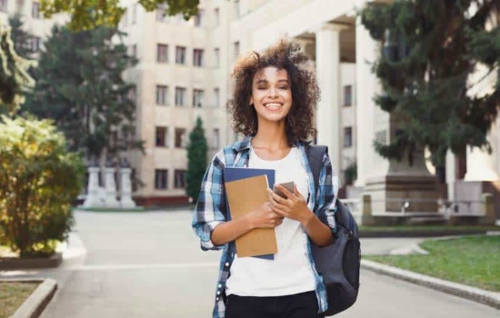 Young female music PhD student on campus