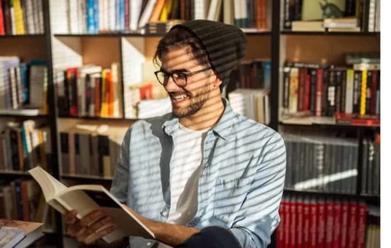 Man reading book in library