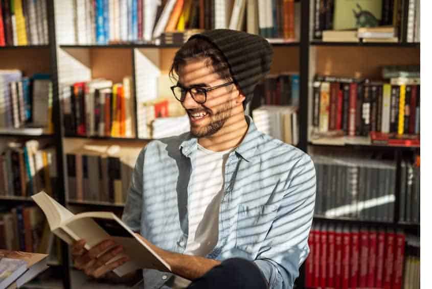 Man reading book in library