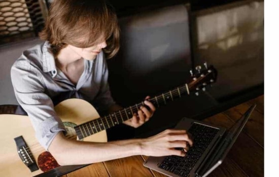 Online music class with student guitar player