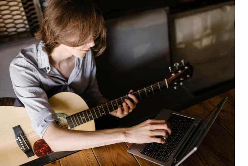 Online music class with student guitar player