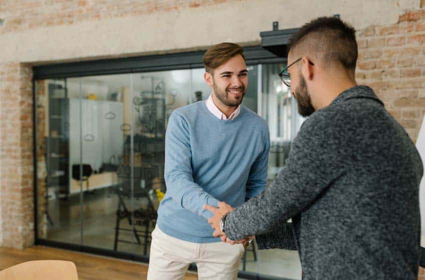 Music industry student shaking hands with potential employer at internship interview