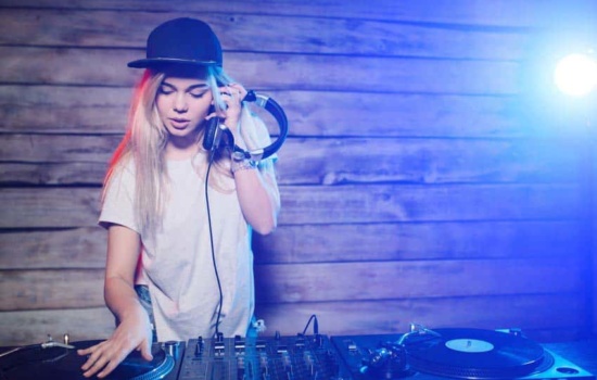 Young woman learning to DJ