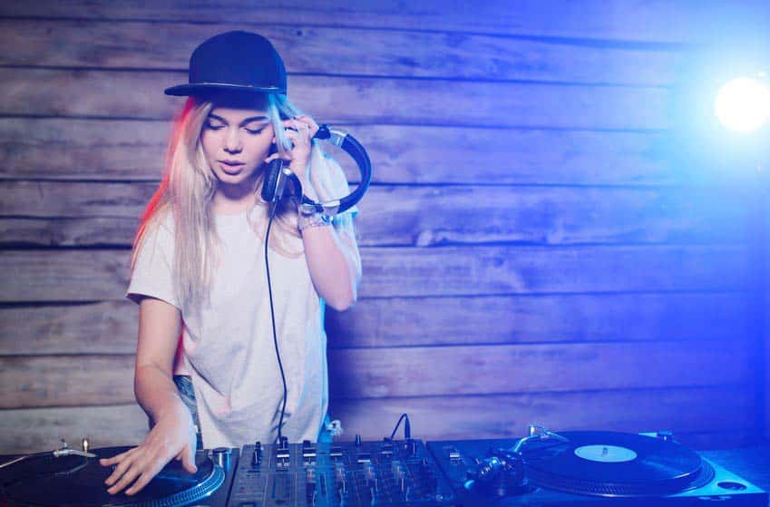 Young woman learning to DJ