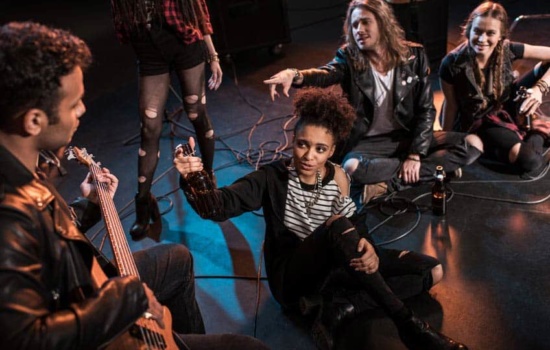 Bandmates hanging out on an empty venue stage