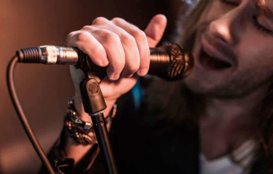 Closeup of male rock singer and microphone
