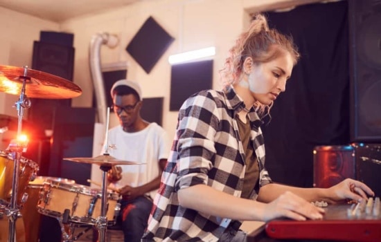 Drummer and keyboard player in rehearsal space