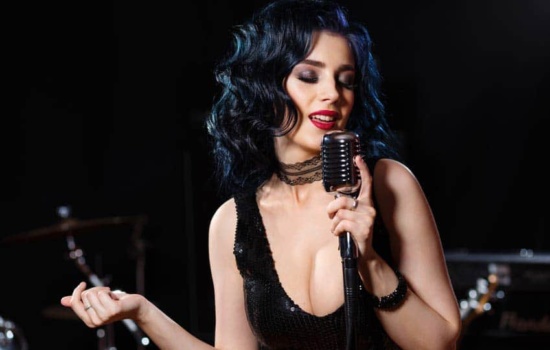 Dark-haired female vocalist at a singing audition