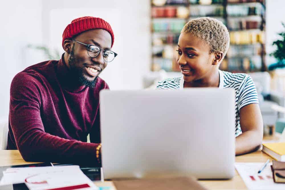 Black male and female musician working on an EPK