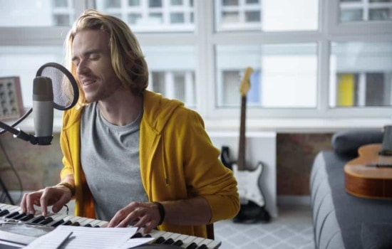 Man singing and playing keyboards in his apartment
