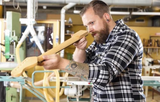 Luthier student making a guitar in the workshop