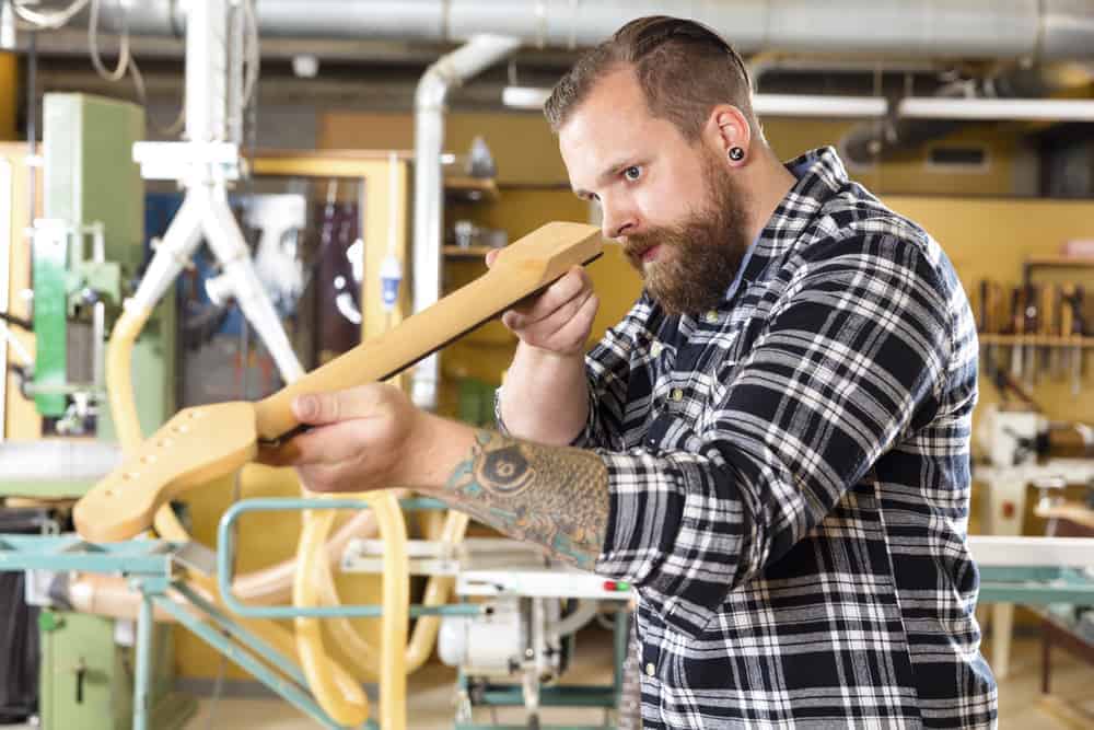 Luthier student making a guitar in the workshop