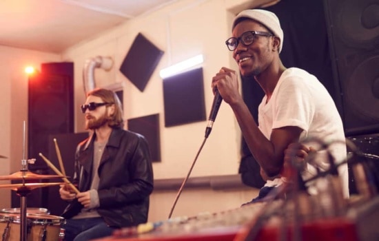 Singer and drummer in rehearsal studio