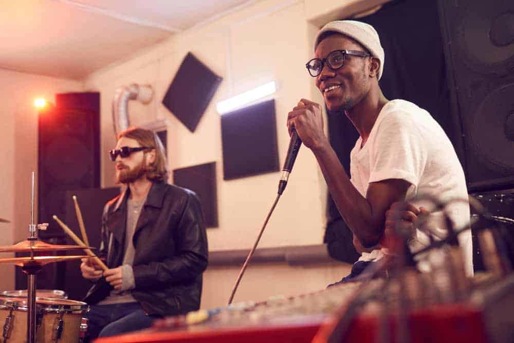 Singer and drummer in rehearsal studio