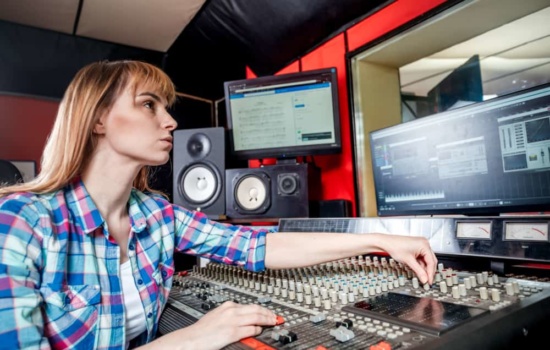Audio engineer using DAW in recording studio