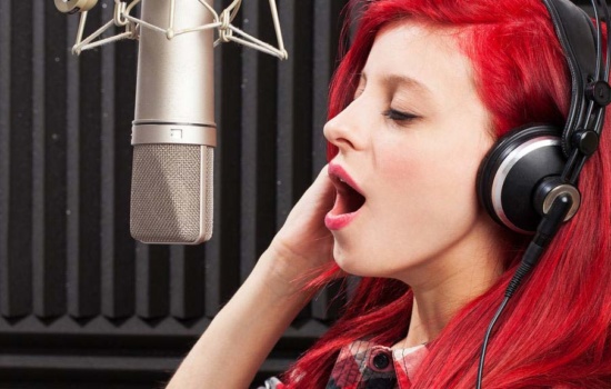 Acoustic panels with female singer and microphone in foreground