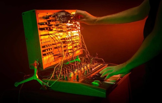 Eurorack setup with musician playing Arturia Rackbrute