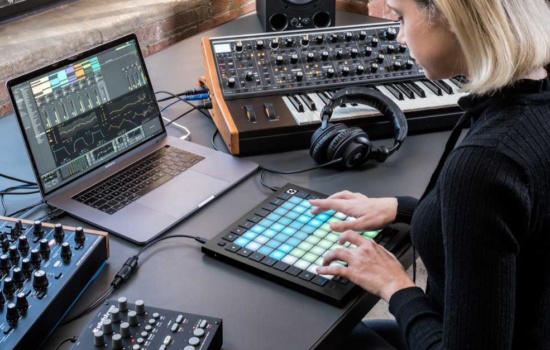 Woman using one of the best midi controllers, the Novation Launchpad Pro