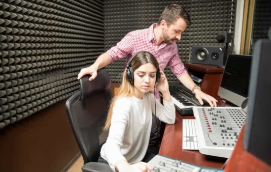 Young audio engineers working together in recording studio