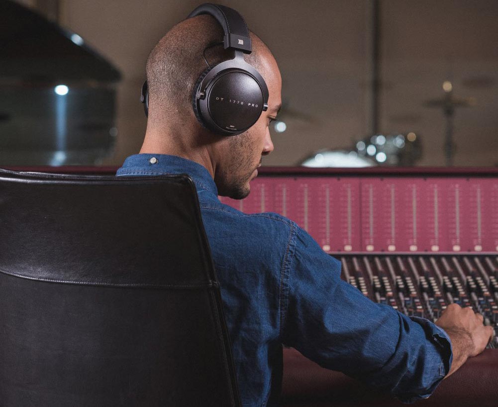 Recording Engineer with Beyerdynamic headphones in studio