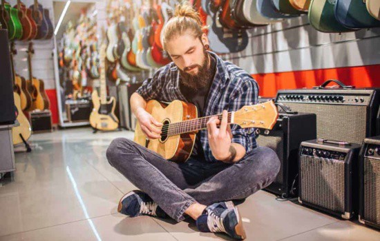 Man playing guitar at instrument store