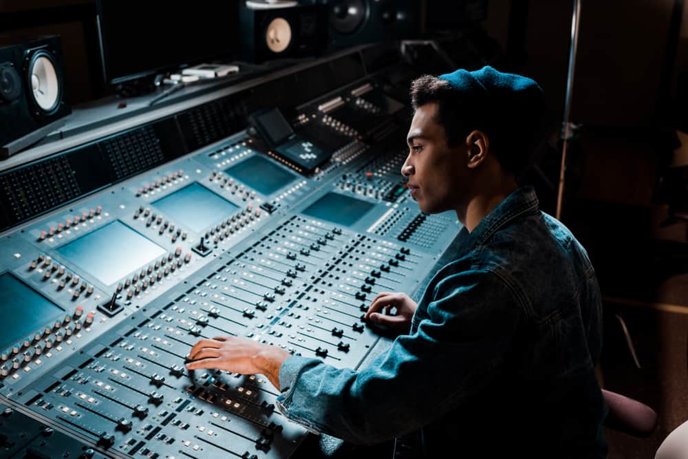 Music producer behind professional mixing console