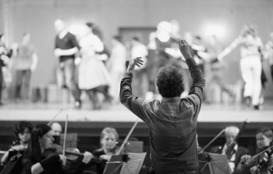 Conductor leading studio orchestra while recording for a film