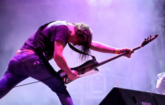 Rock star performing on stage with his guitar