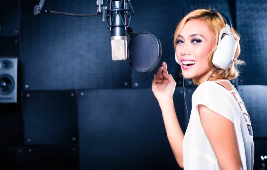 Singer in recording studio practicing vocal warmups