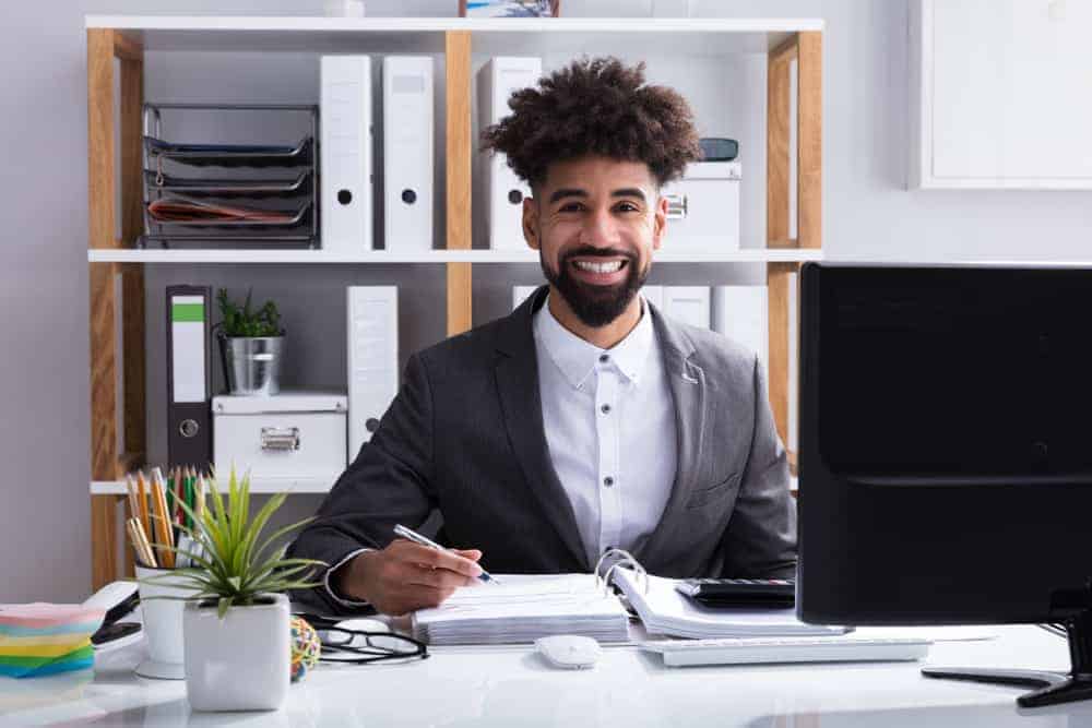 Music business accountant in office with computer