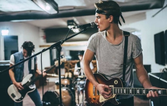 Recording group rehearsing in studio