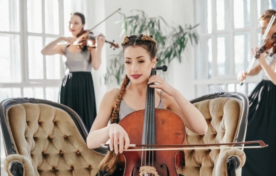 Female cello player with violinists