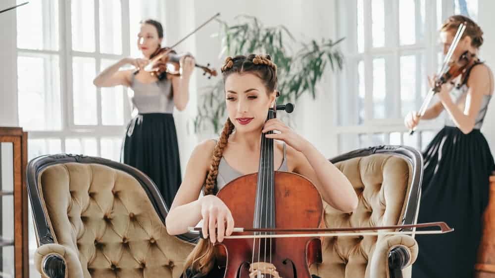 Female cello player with violinists