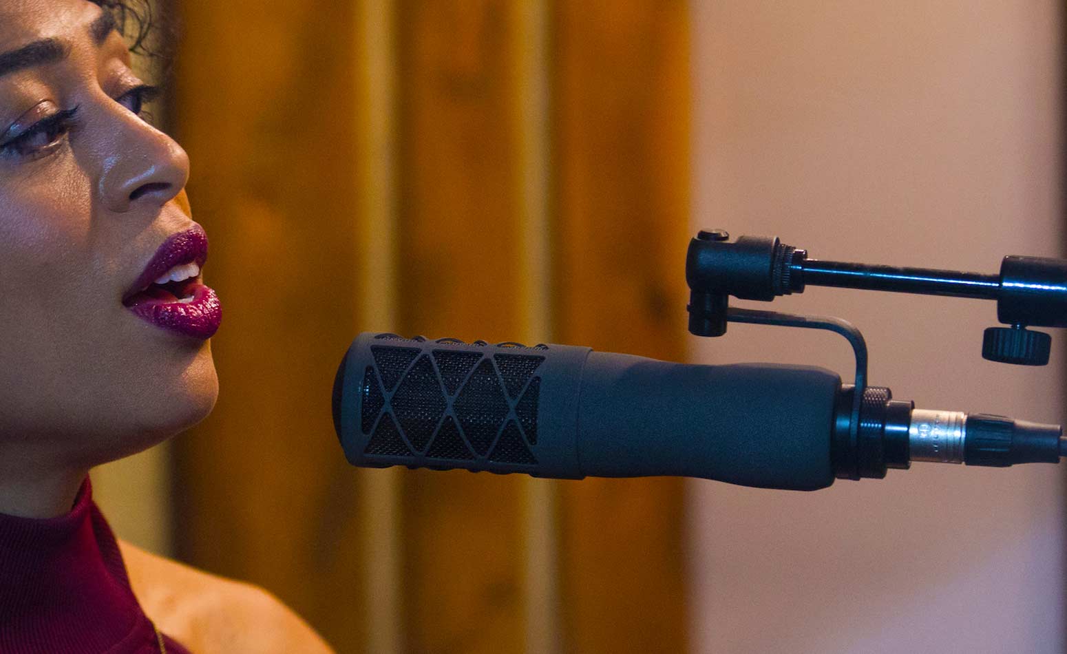 Young black female singer using an Earthworks vocal mic