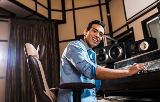 Production Music Writer working in his recording studio