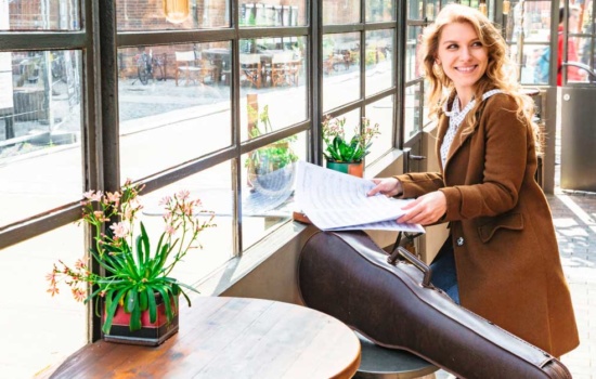 Female music student with violin at music conservatory