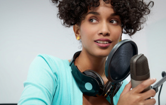 Black female Radio DJ with microphone and headphones