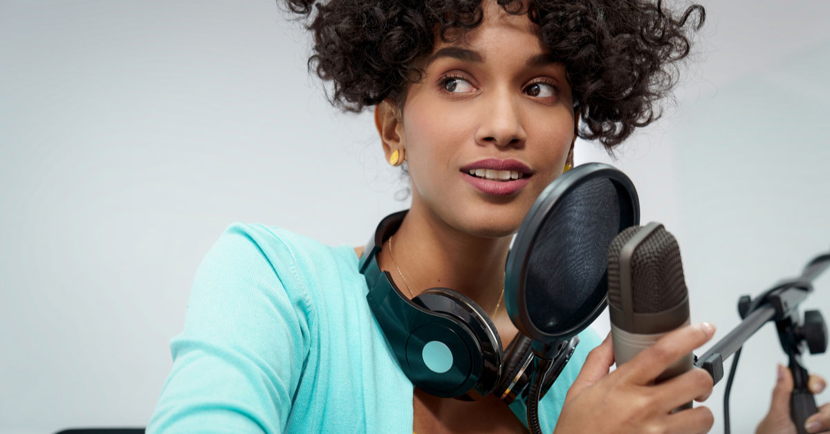 Black female Radio DJ with microphone and headphones