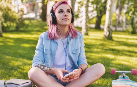 Woman listening to Spotify on her phone outdoors