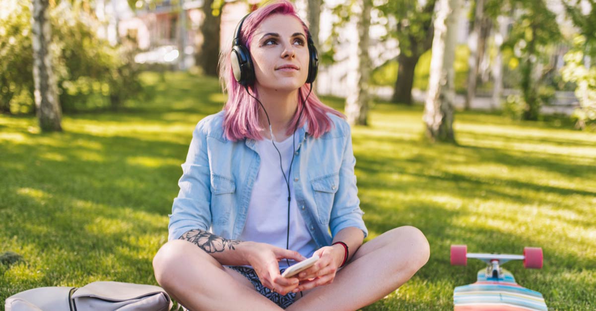 Woman listening to Spotify on her phone outdoors
