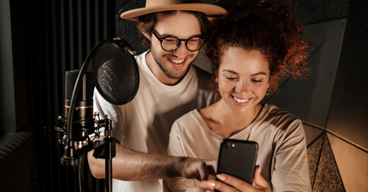 Male and female bandmates taking photos to promote their music in studio