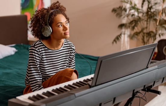 Young Black female musician writing a song for music publishing