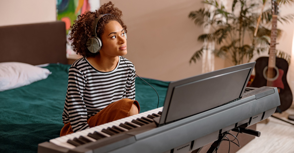 Young Black female musician writing a song for music publishing