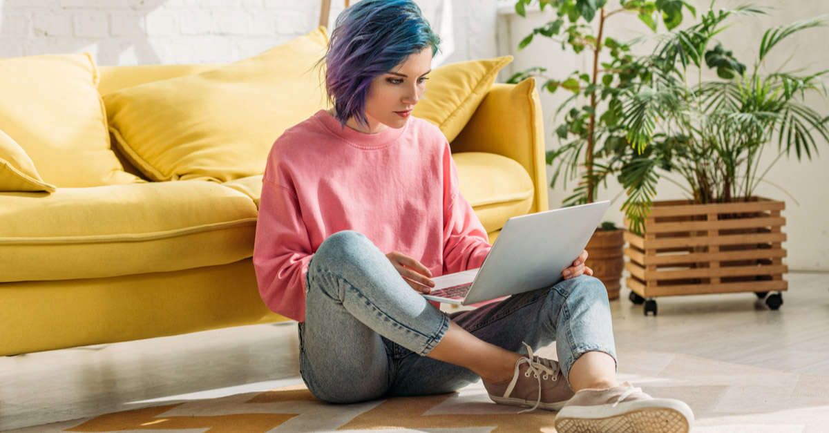 Young female artist creating an EPK on her laptop