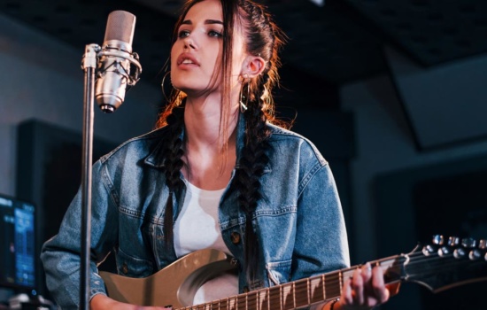 Female Guitarist in recording studio