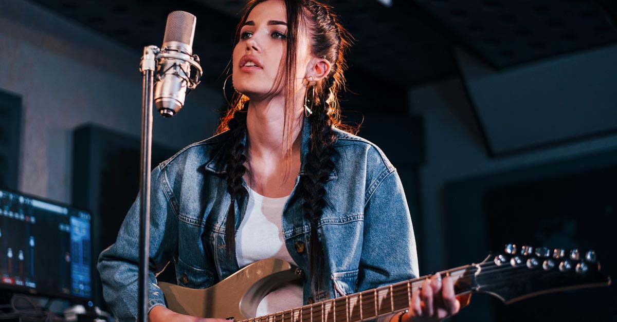 Female Guitarist in recording studio