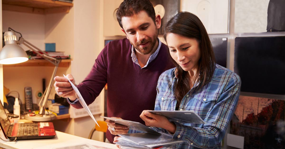 Male and female friends starting a record label at home