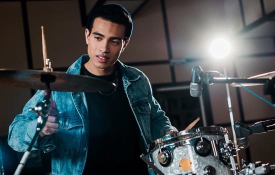 Young Black male Drummer playing the drums